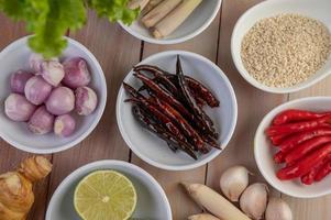 Red onions, lemon, lemongrass, chilies, garlic, galangal, and lettuce photo