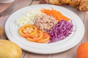 Tuna salad with carrots, tomatoes and cabbage photo