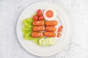 Sausage links with peppers and cucumbers photo