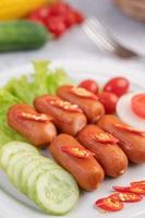 Sausage links with peppers and cucumbers photo
