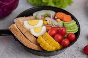 Vegetable salad with bread and boiled eggs photo