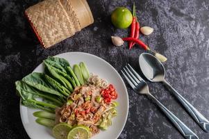 Spicy lime pork salad on a bed of greens photo