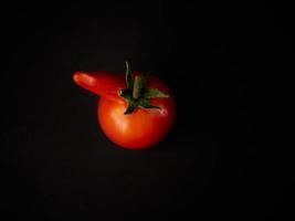 Red tomato on a black background photo