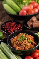 Sweet pork with cucumbers, long beans, tomatoes and side dishes photo