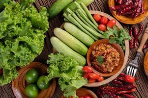 Sweet pork in a wooden bowl with ingredients photo