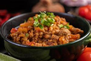 Sweet pork bowl with cucumbers, long beans and tomatoes photo