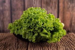 A large bunch of lettuce on wooden background photo