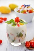 Fruit yogurt smoothie in clear glass photo