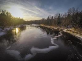 Sun setting  over a river photo