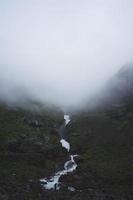 River running through foggy mountains