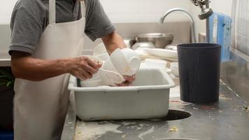 Man washing dishes photo