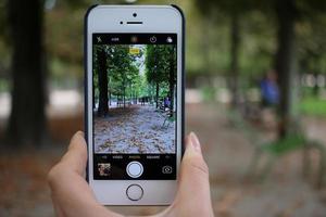 France, 2020 - Person taking photo using a silver iPhone 5s