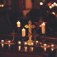 Cross surrounded by candles photo