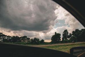 View of a cloudy sky from a car photo