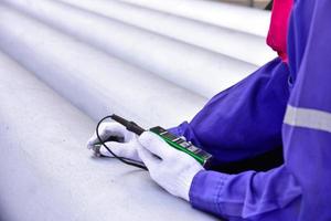 Inspector measuring thickness the pipe photo