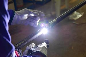 Welder is welding the pipeline with Tungsten Inert Gas photo