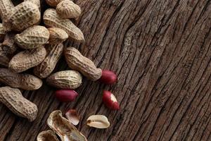 Peanuts on a wooden background. Top view. photo