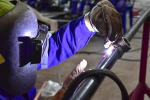 Welder working with protective equipment photo