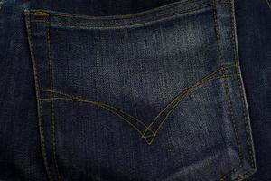 Texture of jeans pocket close up, background. photo