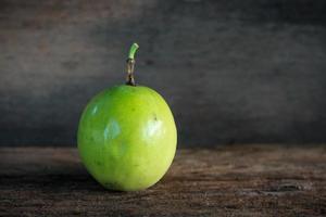 Green fruit on a wood background photo