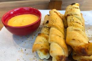 Bread stick with dip cheeses on a board in restaurant photo