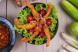 Shrimp deep fried in batter on salad photo