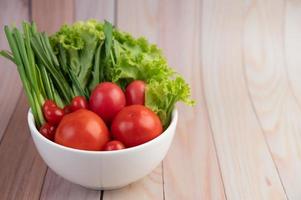 Bowl of tomatoes and spring onions photo