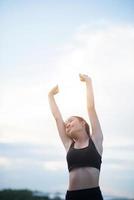 Happy smiling athletic teen with arms outstretched photo