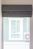 Grey curtain above a window photo