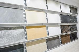 Colorful samples of a stone tile in store. Marble and granite flooring a most popular choice for modern kitchens and bathrooms. photo