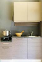 Close-up of stainless steel cooking pot on induction hob in contemporary modern home kitchen. photo