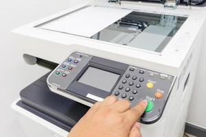 Man copying paper from Photocopier with access control for scanning key card photo