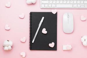 Minimal Office desk table with heart Paper clip, Keyboard computer, mouse, white pen, cotton flowers, eraser on a pink pastel table with copy space for input your text, valentine day concept, flat lay, top view