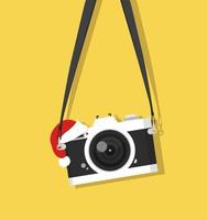 vintage camera hanging with Santa hat vector