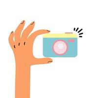 Hand holding a photo camera vector