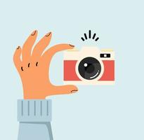 hand taking a photo with camera vector