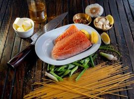 Steamed salmon beside sliced of lemon photo