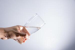 Pouring water out of the glass photo