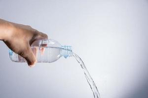 Pouring water out of the bottle photo