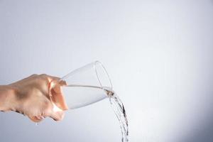 Pouring water out of the glass photo