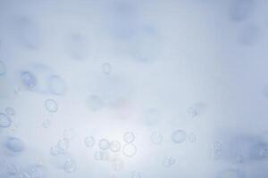 Bubbles in front of greyish-white background photo