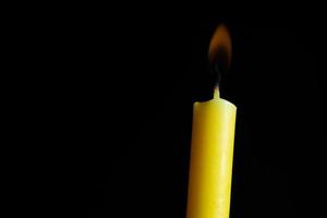 Candle light on black background photo