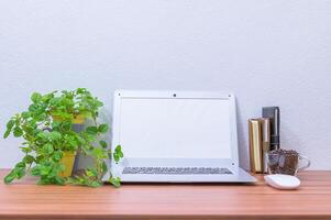 Laptop and other objects on the desk photo