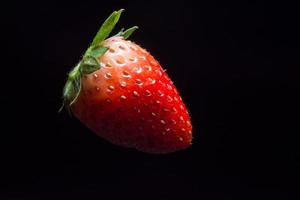 Strawberry on black background photo