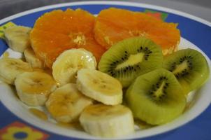 Plate with pieces of fruits photo