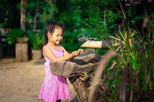 Little Asian girl washing her hands before eating dinner in the evening photo