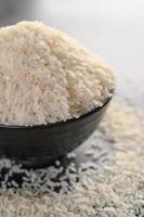 Milled rice in a black bowl photo
