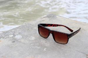 Sunglasses near a pool photo