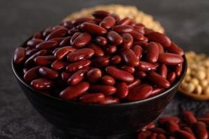 Red beans in a wooden bowl and brown spoon photo