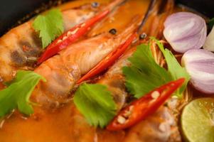 Thai hot spicy soup called tom yum kung with shrimp photo